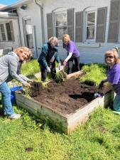 Members of the Snufftown Garden Club work in the raised beds at the food pantry at the Partnership for Social Services in Franklin. (Photos provided)