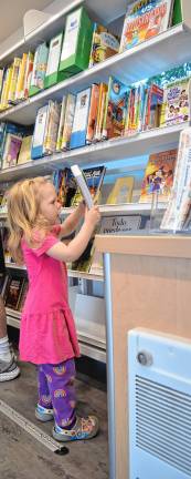New mobile library launched <b>Mavis Clawson, 2, of Sandyston looks at books in Sussex County’s new mobile library, Dot. </b>