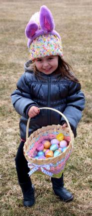 Ella Libhart of Wantage shows her filled Easter Basket she collected at the Woodbourne Park Easter Egg Hunt on Saturday.
