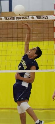 Vernon's A.J. Rodriguez hits the ball towards the other side of the net.