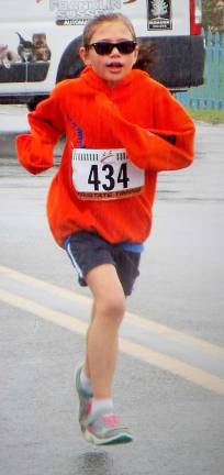 Runners brave weather in O.S.C.A.R. 5K-9 race Milly Dobbs, 7, of Sparta bears the rain with a smirk and a sweatshirt.
