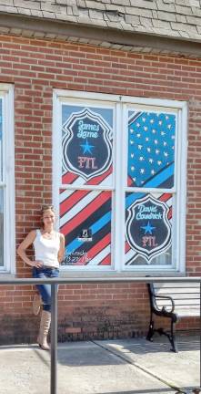 Kim Lonsky with a window painting at Bathing Beauties in Ogdensburg (Photo provided)