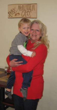 PHOTOS BY JANET REDYKE Chocolatier and caf&#xe9; owner Lynn Anderson poses in her cozy caf&#xe9; with grandson Chase.