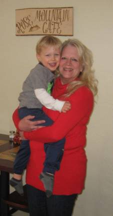 PHOTOS BY JANET REDYKE Chocolatier and caf&#xe9; owner Lynn Anderson poses in her cozy caf&#xe9; with grandson Chase.