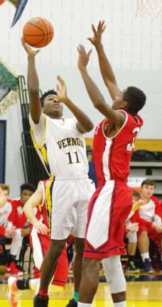 Vernon's Levi Burrell releases the ball towards the basket while covered by Lenape Valley's Michael Josephs.