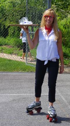 A lot of 50’s stuff going on at seniors picnic Vernon Township Recreation Project Coordinator Mishelle Downtain got into the act by transporting food on roller skates.