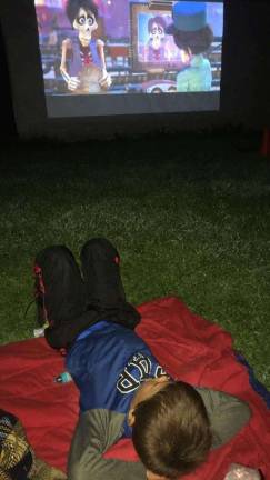 Collin Sensbach watches &quot;Coco&quot; under the stars.