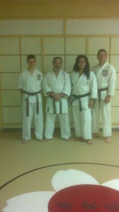 Daniel Nasca, left and Joe Miller have both achieved the rank of San-Kyu, or Brown Belt, in June, 2014, under Sensei Ghandi Kadkoy, pictured with his wife, Elizabeth. The Academy of Japanese Koei- Kan Karate-Do is located at 75 Sparta Road in Newton, and is open to students of all ages. For more information call 973-383-1212.