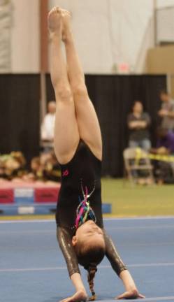 Westy's Gymnastics hosts state championships Samie Copley of Vernon does a hand stand.