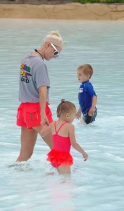 Certified Lifeguard Jessica Scioscia of Oak Ridge escorts a young girl into the pool.