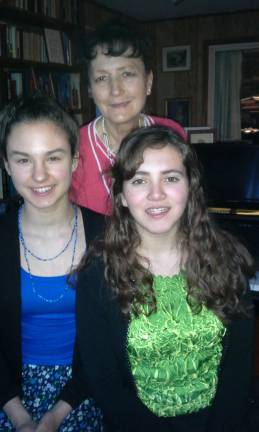 Maya Rakoczy, left, and Mikhaila Sanchez, right, are pictured with their teacher Margaret Korczynski.