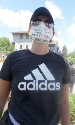 Kat Stellingwerf's mask message: I can't breathe - both left and right sides of her mask, and near her throat on her right on the mask is Eric L Gardner and on the left throat side is George Floyd.