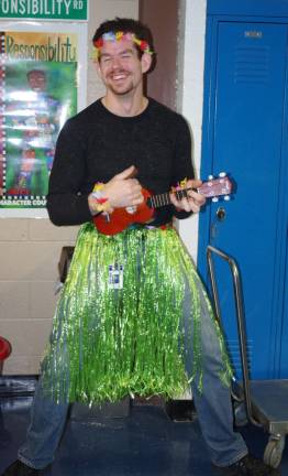 Wearing a brilliant, bright green hula skirt, staffer Christian Frentzko espoused the wonders of ukulele playing.