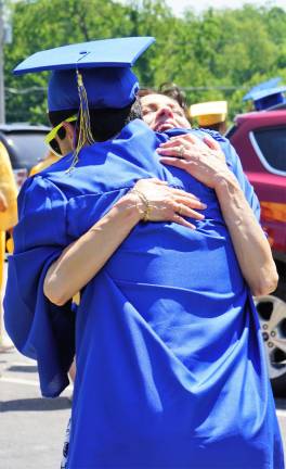 Principal Rosemary Gebhardt gives one of the seniors a big hug.