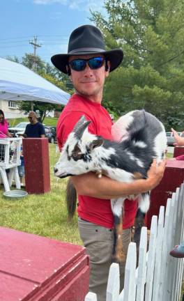 Kevin Kacmarcik of Appalachian Animal Experience holds one of the goats on display.