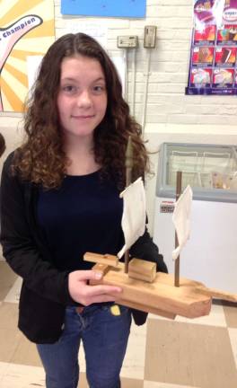 Middle School students celebrate Colonial Day Amanda Craig is shown with a ship.