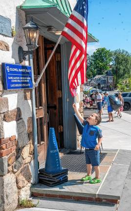 Sparta. Fourth of July events Luke Soblick reaches for an American flag.