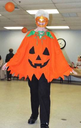 Model Terri Van Emburgh dresses as a pumpkin at the Vernon Senior Center's 2nd Annual Fashion Show.