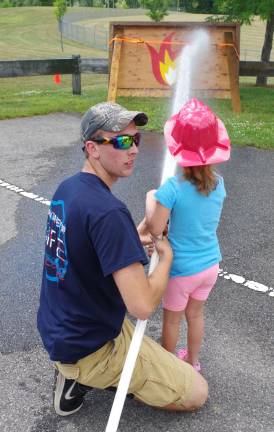 New Beemerville Volunteer Fire Department firefighter Kristian Rokosny helped the children put out imaginary fires.