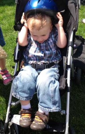 Photos by Laurie Gordon Thomas Nykaza of Stillwater, puts on his new bike helmet. He was at the festival with his sisters and dad.