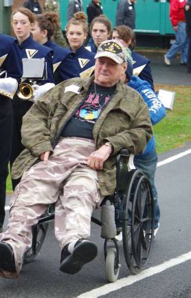 Getting a welcome hand up the hill and leading a long line of veterans was U.S. Army veteran William F. Harris.