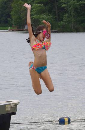 Graceful and daring at the same time, Morgan Mulvaney, 12, performs off the float during the lake community&#xfe;&#xc4;&#xf4;s annual Water Carnival.