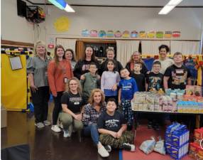 Members of the Autism Spectrum Disorders program at Wantage Elementary School pose with the items they bought for a local food pantry. (Photo provided)