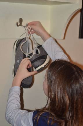 PHOTO BY TERESA SELLINGER A Sussex Middle School student hangs up her running shoes.