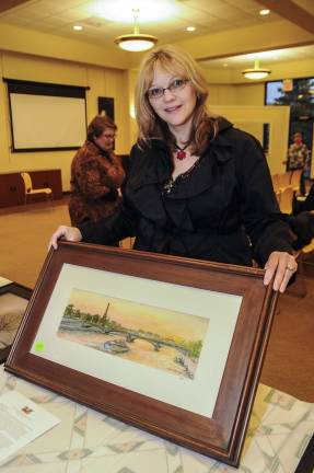 Locals bring color to Sussex County Artist Liza Smith Simpson of Andover and one of her works made about a scene in Paris.