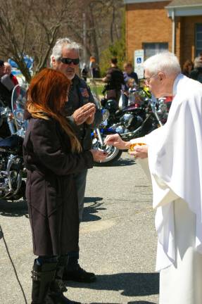 Father Bob distributed Holy Communion to those who wished to receive it during a mass before the Biker Blessing.