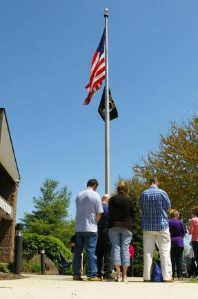 Residents observe the National Day of Prayer in front of the flagpole at the Vernon Township Municipal Center.