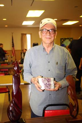 McAfee resident George Pyryt of Spectrum Collectibles brought many treasures including carved wooden statues and the large purple amethyst which he is shown holding in his hands.