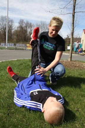 Meghan Miller from Therapeutics Unlimited stretching her son, Max.