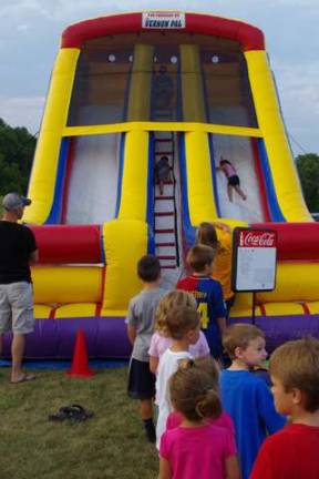 The kids lined up for the PAL inflatable slide that was set up for the evening.