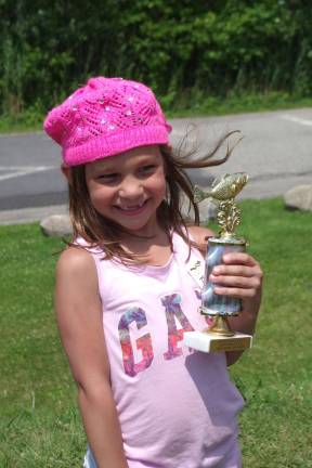 You can't get much happier than Gabriella Cefaloni, 6, who won the trophy she yearned for as a reward for catching the largest fish of the day. A one-pound eight ounce largemouth bass. The trophies were presented by Mark Grammerstorf.