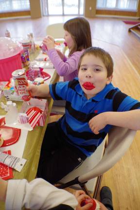 Barry Lakes hosts decorating cake Nicholas Ferreri, 8, proves that cupcake construction is all in the lips.