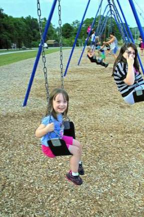 Samantha VanHerwynen, 3, and her sister Kaitelyn, 11, of the Glenwood section of town enjoyed the swings in the playground.