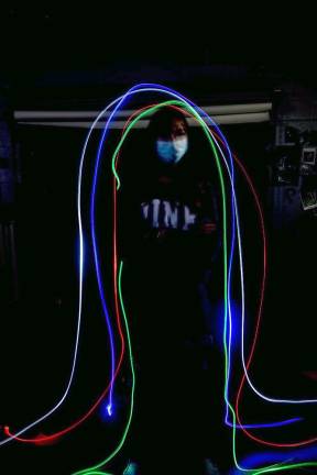 Wallkill Valley photography students learn to paint with light Madison VanderPloeg is standing still, while students Brandon Todd, Lillian Yorke, Keely Korger, and Joskar Diaz passed a light trail around her during the long exposure.