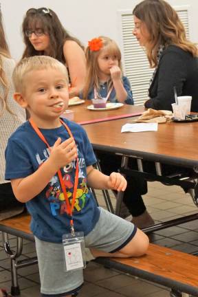 One young man truly likes the apple slices.