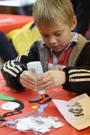 American Legion hosts lunch with Santa Chase Krisanda of Wantage glues Frosty together