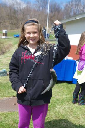Kailee Seeley, 9, of Vernon with a 13-inch rainbow trout that won a First Place trophy for her.