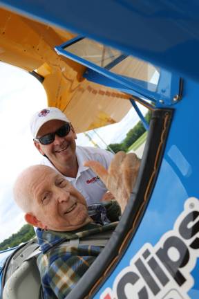 Photos by Don Webb World War II veteran Lawrence Spulick gives the thumbs up as he gets into the Boeing Stearman biplane. He is helped by Tim Newton of the Ageless Aviation Dreams Foundation.