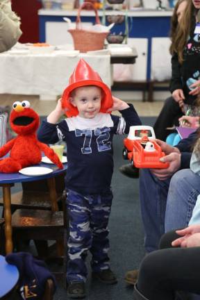 Maksim Spasai of Branchville dressed up like a fireman, playing durring the 35th anniversary celebration for the Sussex Wantage Pre School Learning Center.