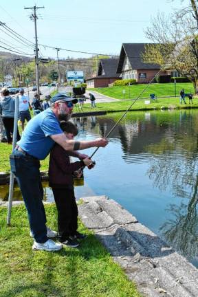 Ronan Dixon, 9, gets help with his fishing pole. The derby was at the pond in front off the Vernon Fire Department.
