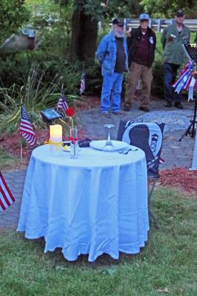 The meaning of the empty table that honors those military personnel who remain prisoners of war was explained during the ceremonies.