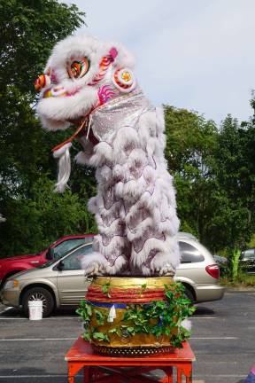 A Chinese lion sits on an ornate drum during Smaglia's celebration.