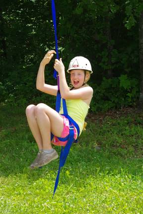 Vernon scout Kelly Witters, 10, is shown on the zip line.