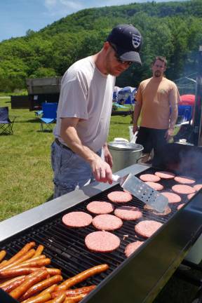 Joe Chromcik of Highland Lakes begins to flip the burgers for lunch on Saturday afternoon.
