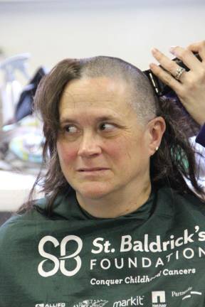 Amy Cosh of Wantage is getting her buzz cut for the fourth year helping at the St. Baldricks fundraiser.