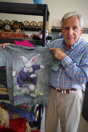 Tom Beccari is shown with a T-shirt, which is The Mountain brand that is made with organic dyes. In the lower left corner of each shirt are the artist&#xfe;&#xc4;&#xf4;s name and the copyright date.